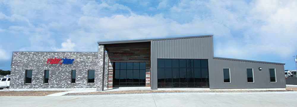 Rabroker’s newer facility, brick and grey metal, with the Rabroker sign